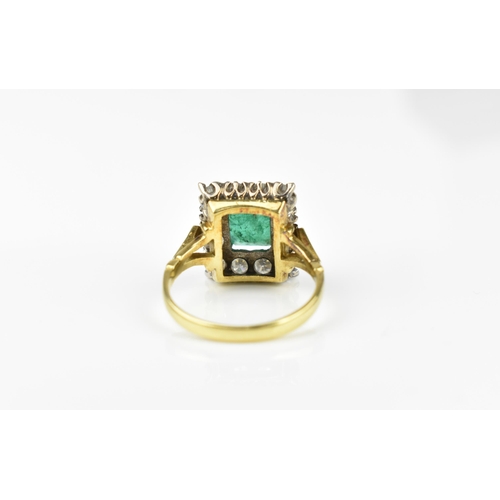 153 - An 18ct yellow gold, emerald and diamond dress ring, with central step cut emerald in a halo of twel... 