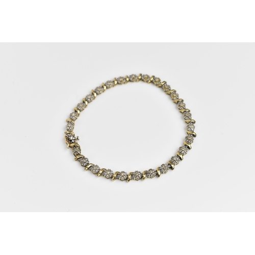 167 - A 9ct yellow gold and diamond bracelet, designed with twenty-seven floral diamond clusters, with cat... 