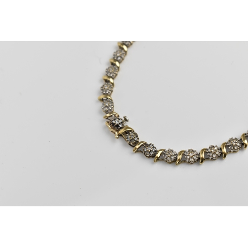 167 - A 9ct yellow gold and diamond bracelet, designed with twenty-seven floral diamond clusters, with cat... 