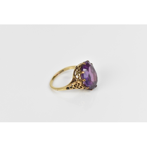 168 - A 9ct yellow gold and alexandrite dress ring, with pierced mount, the shank hallmarked, size N  Loca... 