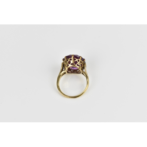 168 - A 9ct yellow gold and alexandrite dress ring, with pierced mount, the shank hallmarked, size N  Loca... 