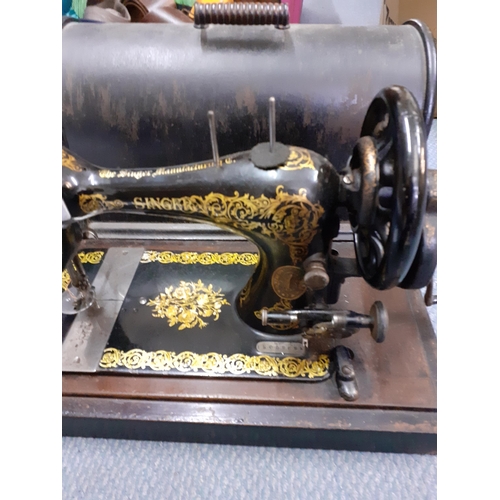 143 - An 1870's Singer sewing machine in oak case, serial number 12059692
Location:1.5