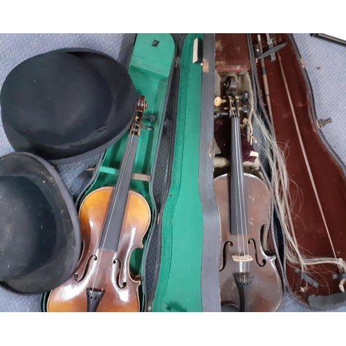 150 - An early 20th century violin, no label, with two bows in a fitted case together with another later v... 