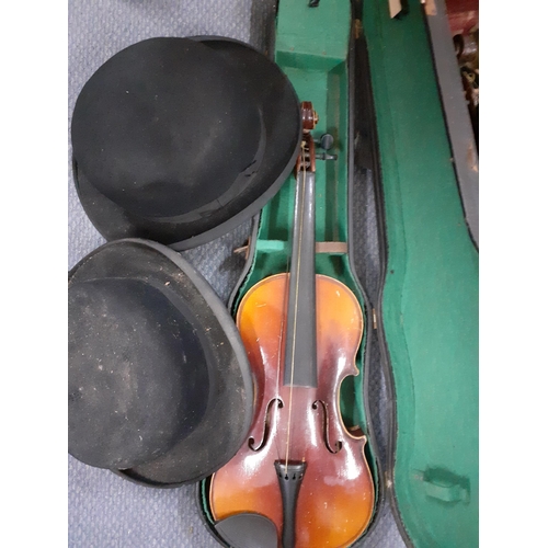 150 - An early 20th century violin, no label, with two bows in a fitted case together with another later v... 