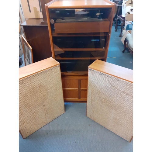 160 - A vintage music system in a teak housing unit with smoky glazed door above a record rack, comprising... 