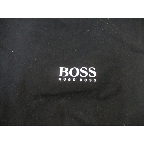 166 - Hugo Boss-A black leather briefcase in branded dustbag with key together with a light brown leather ... 