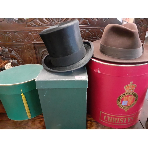 167 - A Christies fine brown fur felt Trilby hat, UK size 7 and 1/8, together with a Christies red cardboa... 