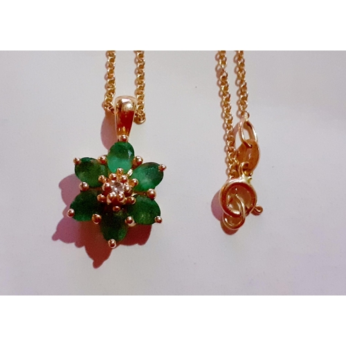 182 - A 14ct gold chain and a 14ct gold and 6 emerald stone pendant in the form of a flower, total weight ... 