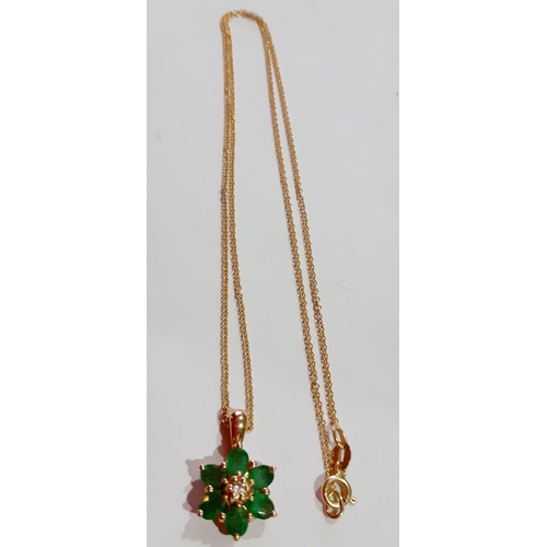 182 - A 14ct gold chain and a 14ct gold and 6 emerald stone pendant in the form of a flower, total weight ... 