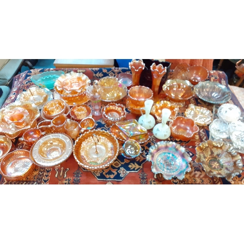 242 - A collection of Carnival glass to include a Fenton peacock and grape bowl in a purple colour togethe... 