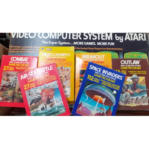 266 - A retro Atari video computer system in original box together with six boxed games to include Space I... 