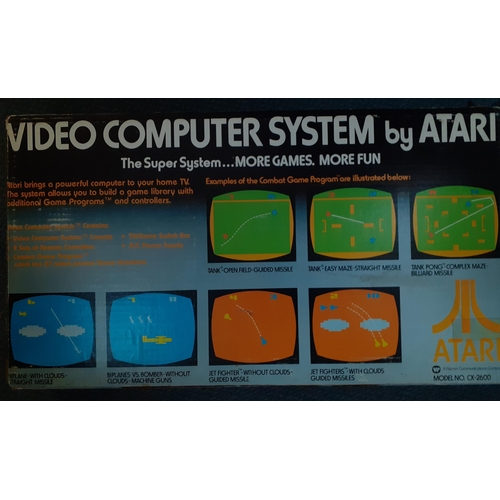 266 - A retro Atari video computer system in original box together with six boxed games to include Space I... 