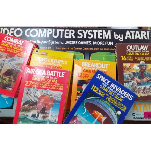 266 - A retro Atari video computer system in original box together with six boxed games to include Space I... 