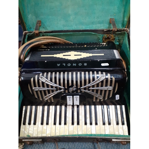 162 - A Sonola 1101 accordion with pearlescent buttons, a clarinet and master key in a green felt lined ca... 