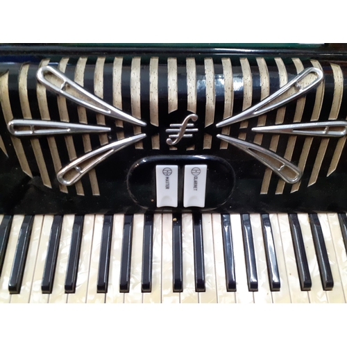 162 - A Sonola 1101 accordion with pearlescent buttons, a clarinet and master key in a green felt lined ca... 