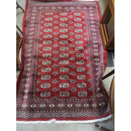 201 - A modern handwoven Middle Eastern red ground rug with elephant gulls, and multiguard border 195cm x ... 