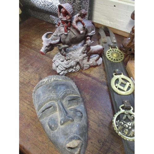 203 - A group of African, Asian and Oceanic ethnographica to include an African carved wooden mask, New Ze... 