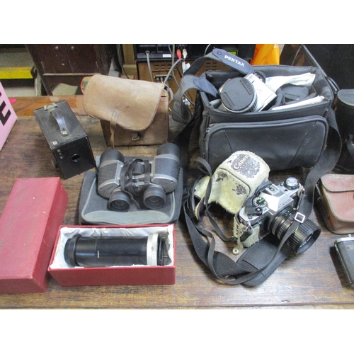 211 - A selection of vintage film cameras, camera accessories, and cased binoculars to include a Nettar ca... 