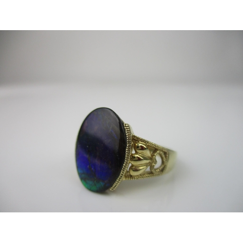 218 - A D'Yack 14k yellow gold and oval opal doublet ring, with beaded and pierced heart decoration to the... 