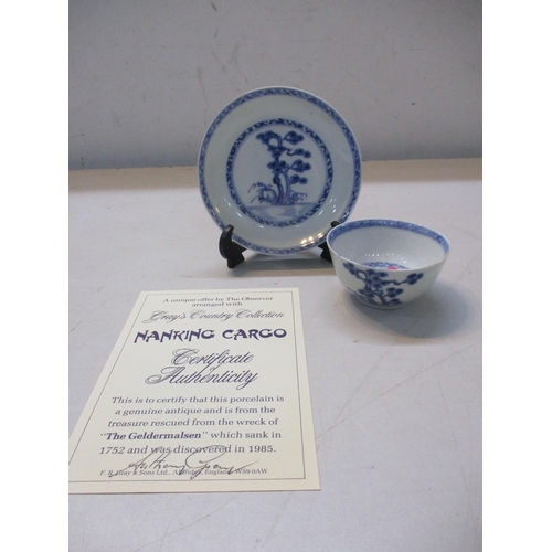 230 - An 18th century Chinese blue and white Nanking Cargo porcelain tea bowl and saucer, decorated with p... 