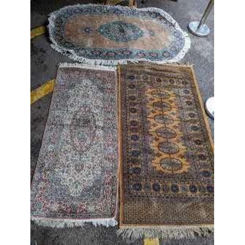 282 - Three rugs to include a Middle Eastern yellow ground rug with geometric designs and tasselled ends L... 