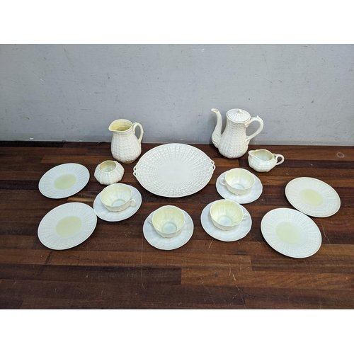 297 - A Belleek cream glazed coffee/tea set of shell design comprising four cups and saucers, a coffee pot... 