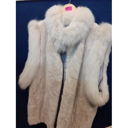 65 - A late 20th Century white faux fur sleeveless coat with arctic fox fur collar and shoulder trim A/F,... 