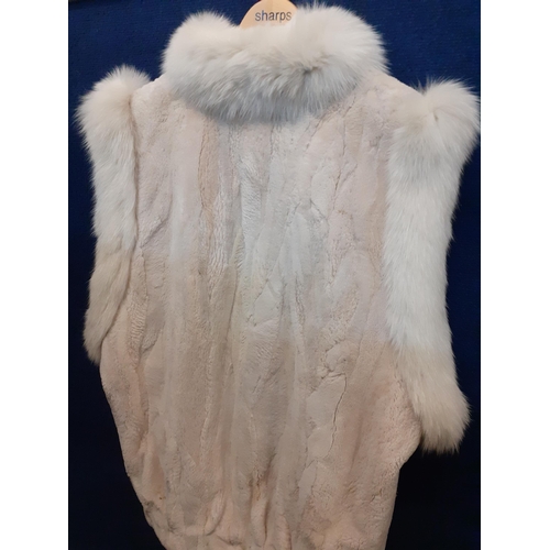 65 - A late 20th Century white faux fur sleeveless coat with arctic fox fur collar and shoulder trim A/F,... 