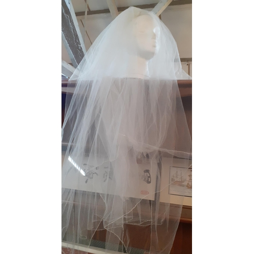 64 - A vintage 4 tier white netted wedding veil with comb attachment, longest length measures 120cm. Loca... 