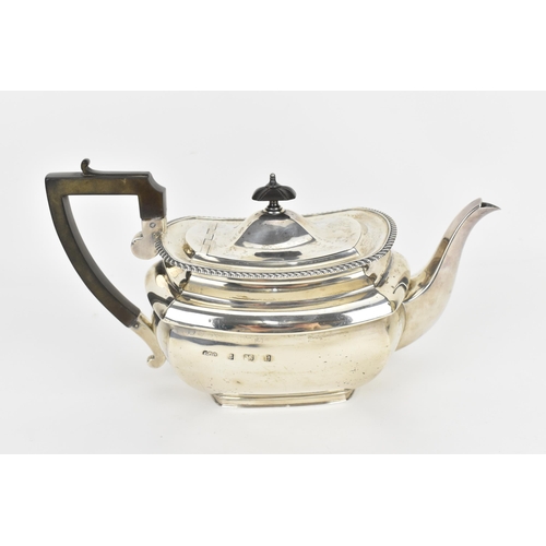 135 - An Edwardian silver teapot by Elkington & Co Ltd, Birmingham 1904, with gadrooned border, turned ebo... 