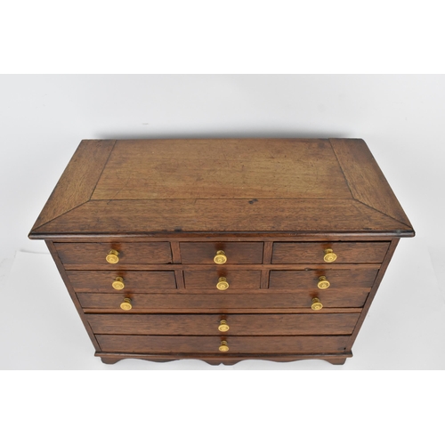 185 - A Regency period mahogany apprentice chest of drawers, with moulded top above two sets of three shor... 