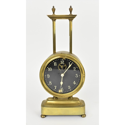 63 - A late 19th/early 20th century brass cased gravity clock having a visual escapement, the Arabic nume... 