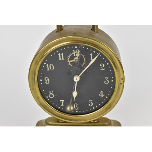 63 - A late 19th/early 20th century brass cased gravity clock having a visual escapement, the Arabic nume... 