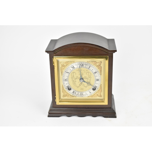 64 - A reproduction Elliott mahogany arched top mantle clock retailed by Garrard & Co Ltd, the gilt dial ... 