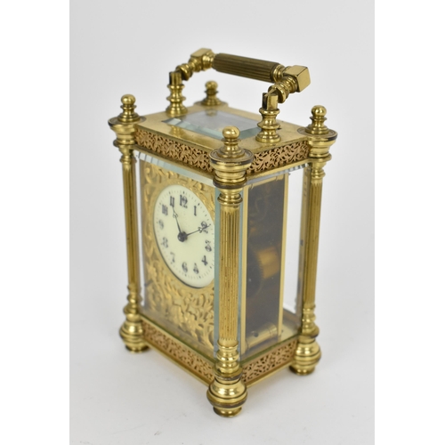 82 - A late 19th/early 20th century gilt metal French miniature carriage clock having turned finials, ree... 