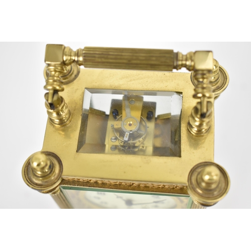 82 - A late 19th/early 20th century gilt metal French miniature carriage clock having turned finials, ree... 