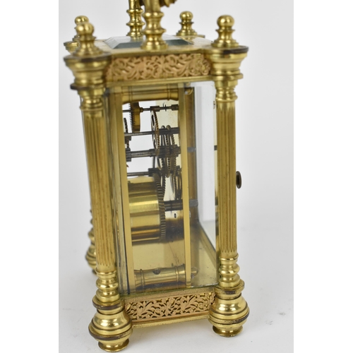 82 - A late 19th/early 20th century gilt metal French miniature carriage clock having turned finials, ree... 