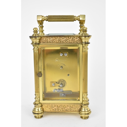 82 - A late 19th/early 20th century gilt metal French miniature carriage clock having turned finials, ree... 