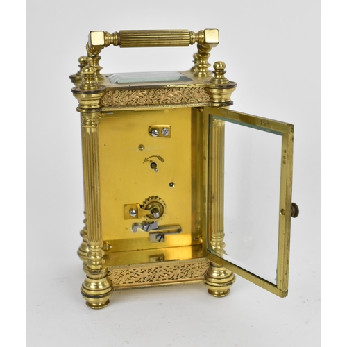 82 - A late 19th/early 20th century gilt metal French miniature carriage clock having turned finials, ree... 