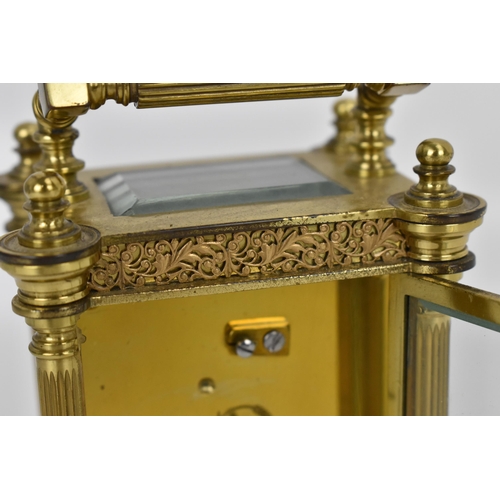 82 - A late 19th/early 20th century gilt metal French miniature carriage clock having turned finials, ree... 