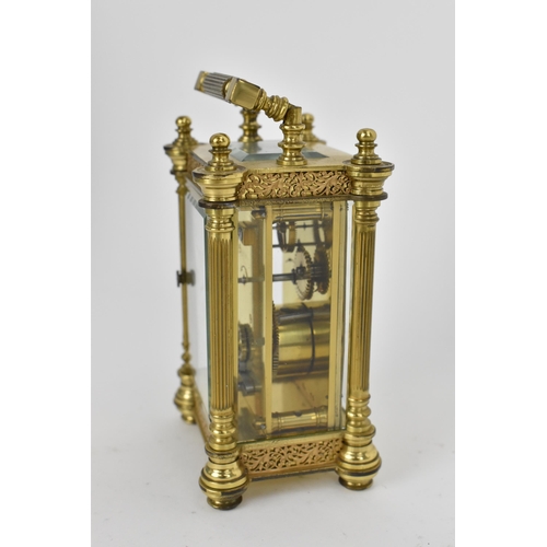 82 - A late 19th/early 20th century gilt metal French miniature carriage clock having turned finials, ree... 