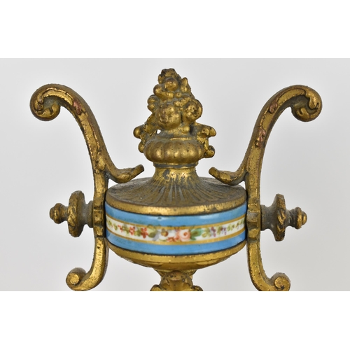 83 - A 19th century French gilt metal mantle clock having a flower shaped finial on a twin handled urn ab... 