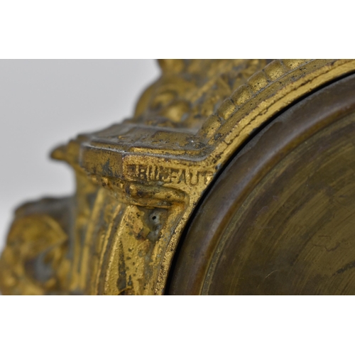 83 - A 19th century French gilt metal mantle clock having a flower shaped finial on a twin handled urn ab... 