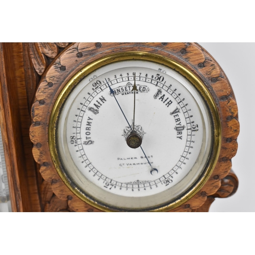 84 - An early 20th century oak combination table clock, barometer and thermometer, having a scroll carved... 