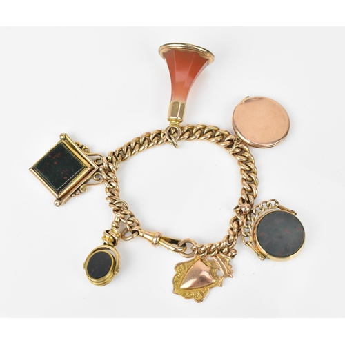 114 - A 9ct yellow gold curb link charm bracelet, with three bloodstone mounted swivel fobs, an agate empt... 