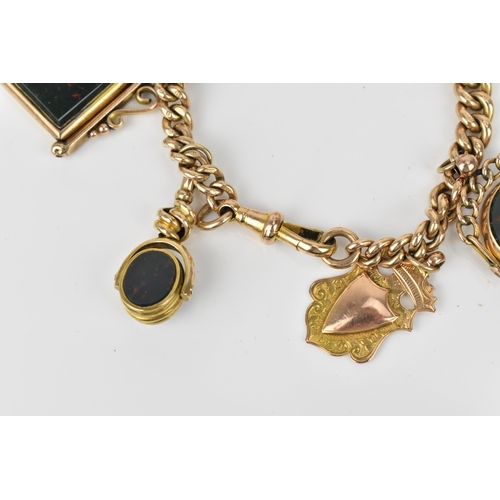 114 - A 9ct yellow gold curb link charm bracelet, with three bloodstone mounted swivel fobs, an agate empt... 