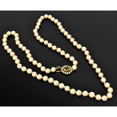 119 - A single strand of cultured white pearls, with 9ct yellow gold, seed pearl and oval cut citrine clas... 