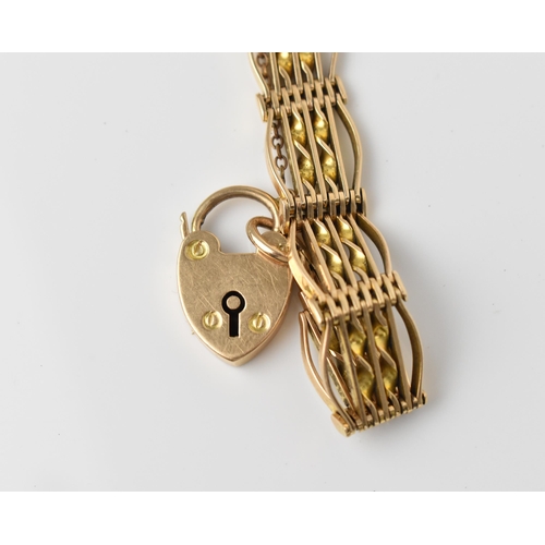 163 - A 15ct yellow gold gatelink bracelet, with heart padlock clasp and safety chain, stamped 15ct, weigh... 