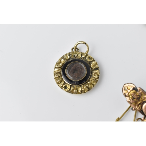 164 - A Victorian yellow metal and enamel mourning pendant with braided hair to the centre and personalise... 