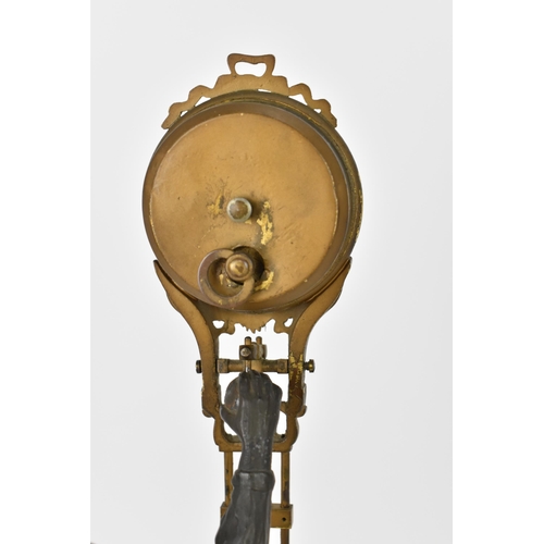 80 - A 19th century novelty mystery clock modelled as a young onion selling boy with hat, mounted on circ... 